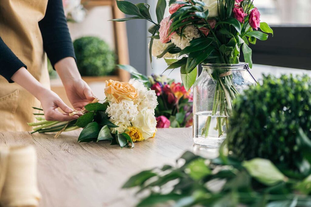 Partial View Of Florist Making Bouquet In Flower Shop